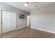Bright bedroom featuring wood flooring, a ceiling fan, closet, and TV at 275 Lakeshore Dr, Davenport, FL 33837