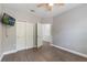 Comfortable bedroom with wood floor, ceiling fan, closet, and TV at 275 Lakeshore Dr, Davenport, FL 33837