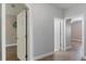 Hallway featuring hard surface floors, neutral walls and multiple doorways at 275 Lakeshore Dr, Davenport, FL 33837