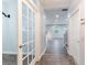Bright hallway features wood floors, French doors and access to the staircase at 275 Lakeshore Dr, Davenport, FL 33837