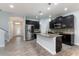 Modern kitchen features an island, stainless steel appliances, granite countertops, and a mosaic backsplash at 275 Lakeshore Dr, Davenport, FL 33837