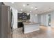 Spacious kitchen features an island, stainless steel appliances, granite countertops and modern pendant lighting at 275 Lakeshore Dr, Davenport, FL 33837