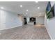 Expansive living space with open layout, wood floors, modern lighting and views of the kitchen at 275 Lakeshore Dr, Davenport, FL 33837