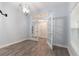 Open living room features wood floors, French doors, and a stylish chandelier light fixture at 275 Lakeshore Dr, Davenport, FL 33837