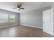 A main bedroom with wood flooring, a fan, and windows that provide natural light at 275 Lakeshore Dr, Davenport, FL 33837