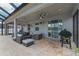 Covered patio with ample seating, ceiling fans, grill, and decorative lighting at 275 Lakeshore Dr, Davenport, FL 33837
