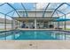 Gorgeous screened-in pool with a covered patio and outdoor seating, perfect for relaxation and entertainment at 275 Lakeshore Dr, Davenport, FL 33837