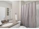 Bathroom featuring a single vanity, framed mirror, and a shower-tub combination with a patterned curtain at 2821 Bookmark Dr, Kissimmee, FL 34746