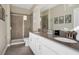 Bathroom featuring a double sink vanity, framed mirror, walk-in shower, and neutral color scheme at 2821 Bookmark Dr, Kissimmee, FL 34746