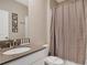This cozy bathroom has a shower, a toilet, and a vanity with a white sink and a shower curtain at 2821 Bookmark Dr, Kissimmee, FL 34746