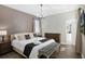 Comfortable bedroom with a large bed, bedside tables, and a tufted bench near the doorway to the bathroom at 2821 Bookmark Dr, Kissimmee, FL 34746