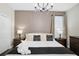 Bedroom featuring a large bed, neutral walls, and a chandelier with a window providing natural light at 2821 Bookmark Dr, Kissimmee, FL 34746