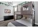 Comfortable bedroom featuring a bunk bed with a play area and a black dresser for storage at 2821 Bookmark Dr, Kissimmee, FL 34746