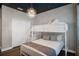 Bright bedroom featuring a bunk bed with white wooden frame and soft gray accents, and a closet at 2821 Bookmark Dr, Kissimmee, FL 34746