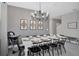 Contemporary dining room with a stylish chandelier, seating for ten, and neutral decor at 2821 Bookmark Dr, Kissimmee, FL 34746