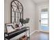 Bright entryway featuring a decorative mirror, console table with decor, and a frosted front door at 2821 Bookmark Dr, Kissimmee, FL 34746