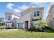 Stylish exterior view of the house highlighting the desert landscaping, modern design, and colored garage door at 2821 Bookmark Dr, Kissimmee, FL 34746