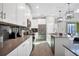 Bright kitchen showcasing white cabinetry, stainless steel appliances, and an island with a sink and pendant lighting at 2821 Bookmark Dr, Kissimmee, FL 34746