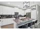 Modern kitchen featuring white cabinets, gray countertops, an island with seating, and stainless steel appliances at 2821 Bookmark Dr, Kissimmee, FL 34746