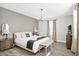 Comfortable bedroom with a large bed, bedside tables, and a tufted bench near the window providing natural light at 2821 Bookmark Dr, Kissimmee, FL 34746