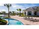 Outdoor pool area with blue lazy river, lounge chairs, and well-maintained landscaping at 2821 Bookmark Dr, Kissimmee, FL 34746
