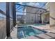 View of the pool and integrated spa and screened-in lanai, perfect for relaxation and privacy at 2821 Bookmark Dr, Kissimmee, FL 34746