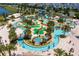 High angle shot of resort-style pool and lazy river with palm trees and landscaping at 2836 Simile St, Kissimmee, FL 34746