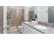 Bright bathroom featuring a double sink vanity, walk-in shower, and modern fixtures at 2836 Simile St, Kissimmee, FL 34746