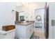 Bathroom with double sink vanity and a door leading to a beautifully decorated room at 2836 Simile St, Kissimmee, FL 34746