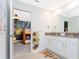 bathroom with white cabinets, double sink, and a cute animal themed rug at 2836 Simile St, Kissimmee, FL 34746
