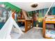 Charming bedroom with unique bunk beds and custom woodland mural creating a playful atmosphere at 2836 Simile St, Kissimmee, FL 34746
