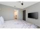 Bedroom with large bed, mounted TV, ensuite bathroom with open doorway at 2836 Simile St, Kissimmee, FL 34746