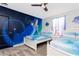 Themed bedroom featuring two beds, ceiling fan and custom Frozen-themed wall art at 2836 Simile St, Kissimmee, FL 34746