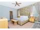 Inviting bedroom with floral wallpaper, a comfortable bed, and soft natural lighting at 2836 Simile St, Kissimmee, FL 34746