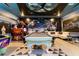 Spacious game room featuring a pool table, arcade games, and unique space-themed decor for entertainment at 2836 Simile St, Kissimmee, FL 34746
