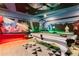 A game room complete with wall art, arcade games, and a pool table at 2836 Simile St, Kissimmee, FL 34746
