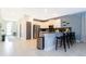 Open concept kitchen features breakfast bar, stainless steel appliances, and a tiled backsplash at 2836 Simile St, Kissimmee, FL 34746