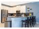 Modern kitchen boasts stainless steel appliances, breakfast bar and sleek white cabinets at 2836 Simile St, Kissimmee, FL 34746