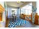 Cozy screened porch with dining set, ceiling fan and decorative blue rug at 2836 Simile St, Kissimmee, FL 34746