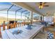 Inviting outdoor patio with view overlooking the water, ceiling fans, and dining area at 2836 Simile St, Kissimmee, FL 34746