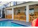 Enclosed patio with pool access and a wooden fence, perfect for outdoor living and entertaining at 2836 Simile St, Kissimmee, FL 34746
