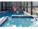 Sparkling pool with built-in spa, basketball hoop, and screened enclosure for outdoor enjoyment at 2836 Simile St, Kissimmee, FL 34746