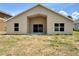 Backyard view of the home's facade, featuring windows and a glass sliding door at 3049 Buckeye Pointe Dr, Winter Haven, FL 33881