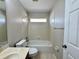 Bathroom with tub shower, sink, toilet, and neutral paint at 3049 Buckeye Pointe Dr, Winter Haven, FL 33881