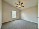 Bedroom boasts neutral walls, carpet, and a fan for comfort at 3049 Buckeye Pointe Dr, Winter Haven, FL 33881