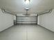 Attached two car garage with a sealed concrete floor and overhead garage door at 3049 Buckeye Pointe Dr, Winter Haven, FL 33881