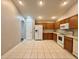 Spacious kitchen featuring tile floors, wood cabinets, and white appliances at 3049 Buckeye Pointe Dr, Winter Haven, FL 33881