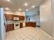 Eat-in kitchen featuring tile floors, wood cabinets, and a convenient breakfast bar at 3049 Buckeye Pointe Dr, Winter Haven, FL 33881