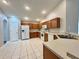 Well-lit kitchen featuring tile floors, wood cabinets, and white appliances at 3049 Buckeye Pointe Dr, Winter Haven, FL 33881