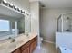Spacious ensuite bathroom features a double sink vanity, tub, and glass enclosed shower at 3049 Buckeye Pointe Dr, Winter Haven, FL 33881